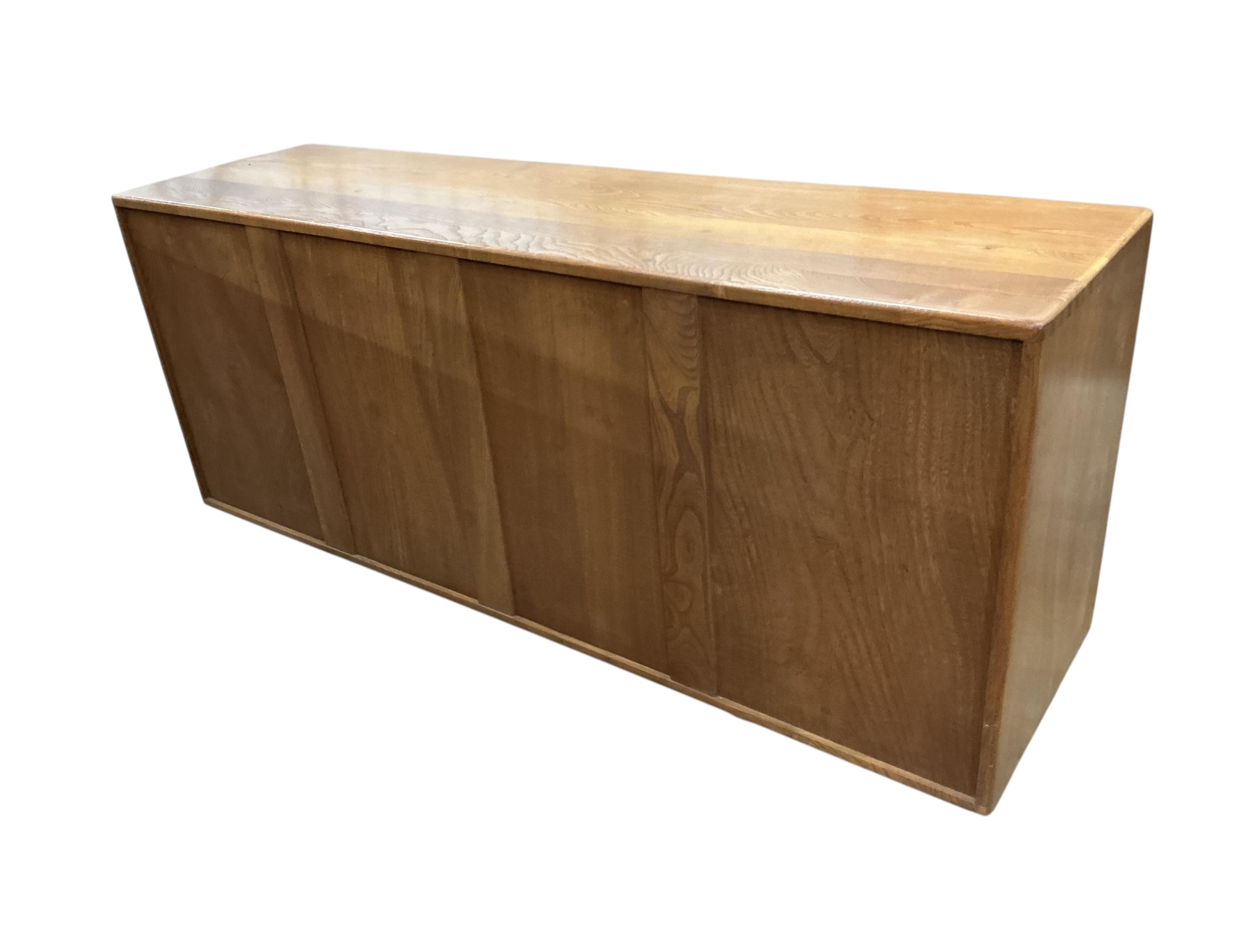 An Ercol Windsor elm sideboard, width 155cm, depth 43cm, height 69cm
